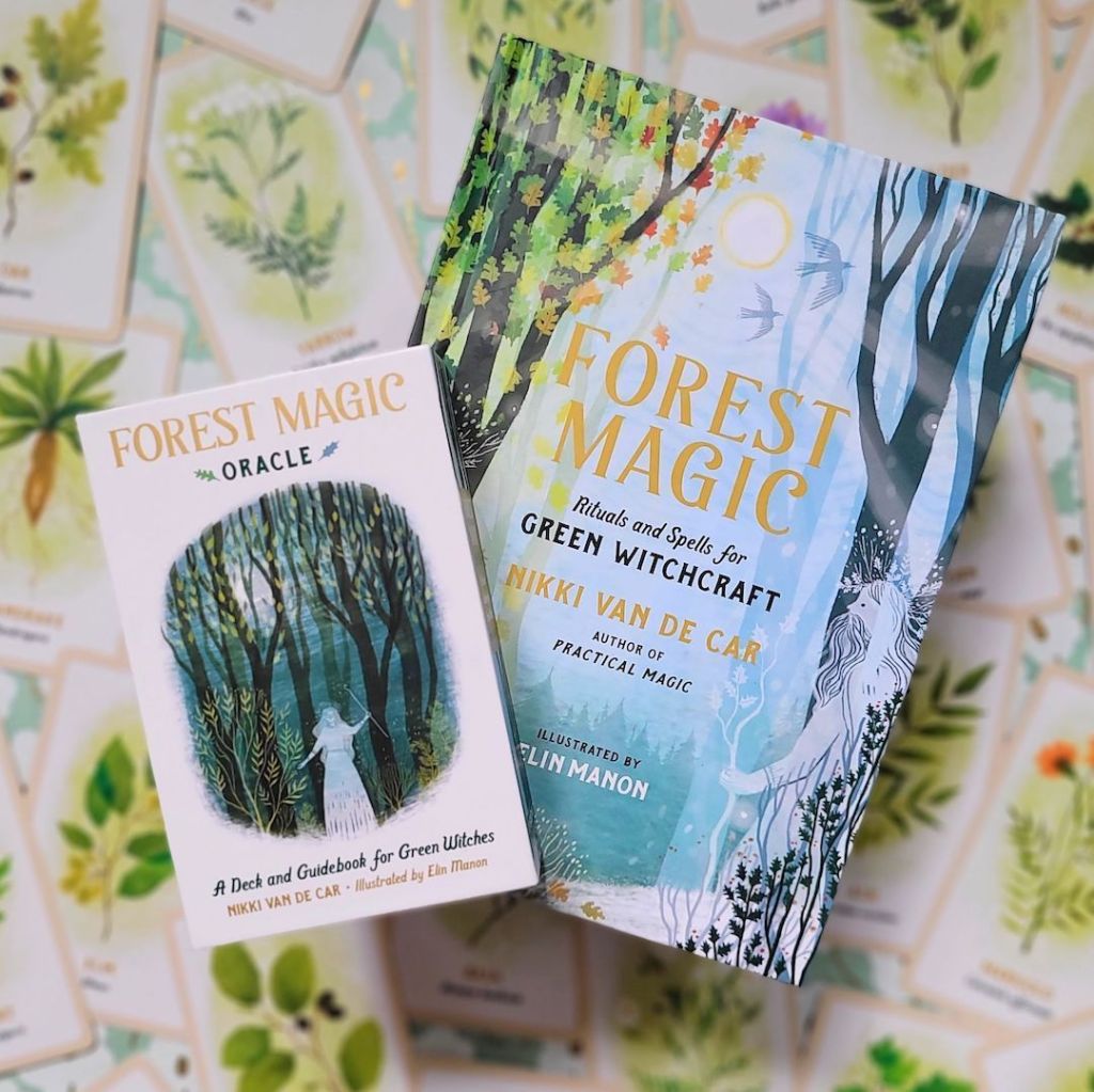 Photo of the hardcover Forest Magic and the Forest Magic Oracle laid above face up cards from the deck