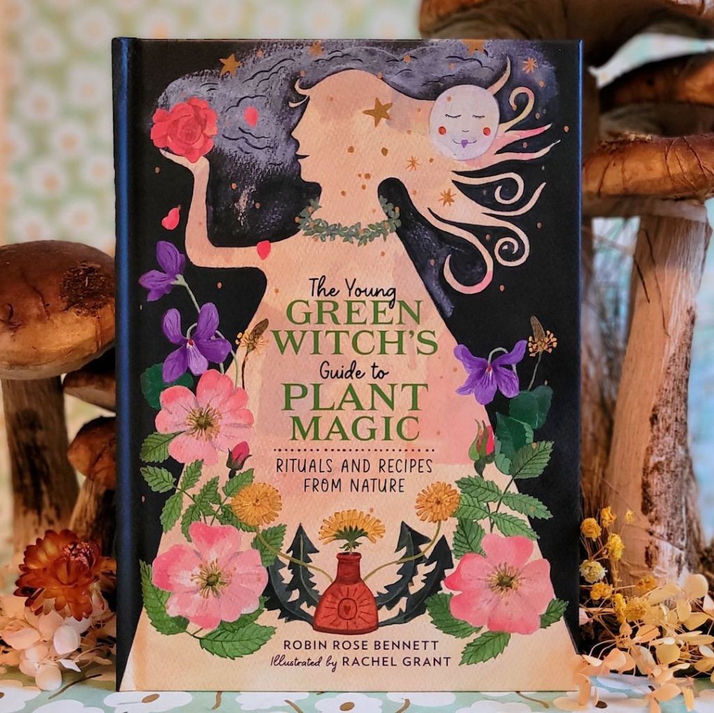 Photo of The Young Green Witch’s Guide to Plant Magic standing among floral and mushroom decor