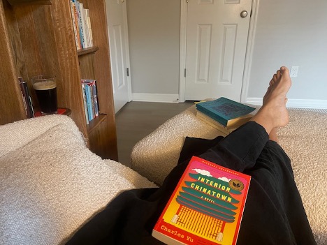 Lissette Decos sitting in white chair reading nook